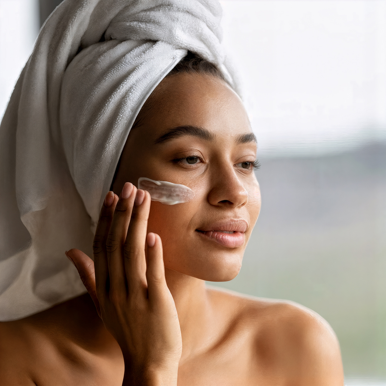 portrait-of-a-young-black-woman-applying-face-cream